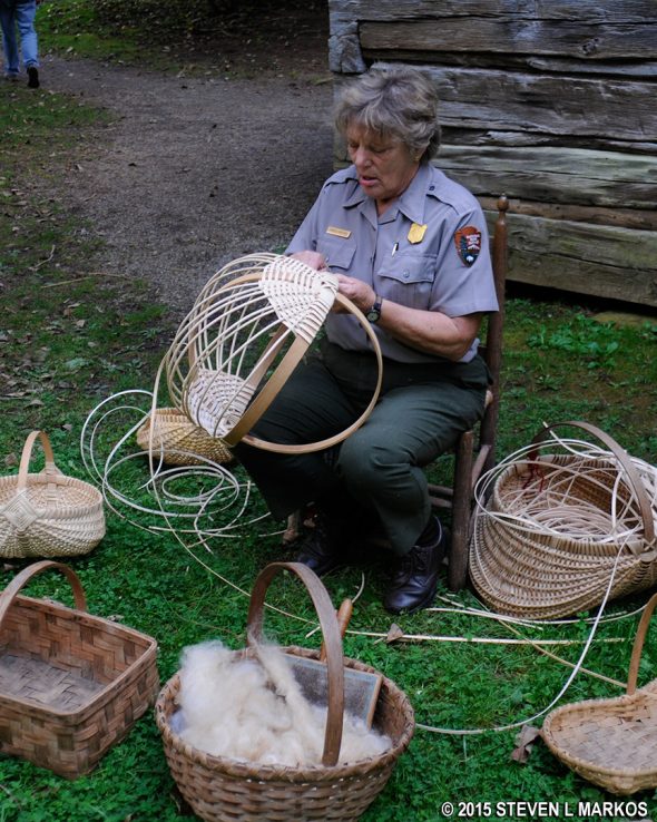 A craftswoman demonstrates basket weaving at Matthews Cabin on the Blue Ridge Parkway