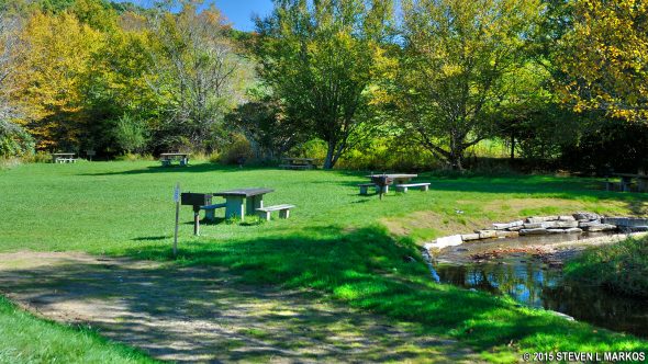 Picnic tables line the creek at Price Park Picnic Area