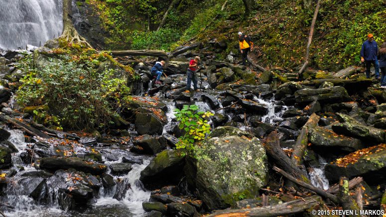 Hikers climb the rocks at the base of the Blue Ridge Parkway's Crabtree Falls