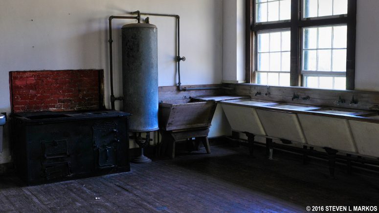 Stove, hot water heater, and wash bins inside the Dungeness Laundry building on Cumberland Island