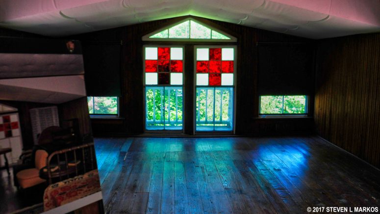 Stained glass Red Cross doors on the upper floor balcony of the Clara Barton House in Glen Echo, Maryland