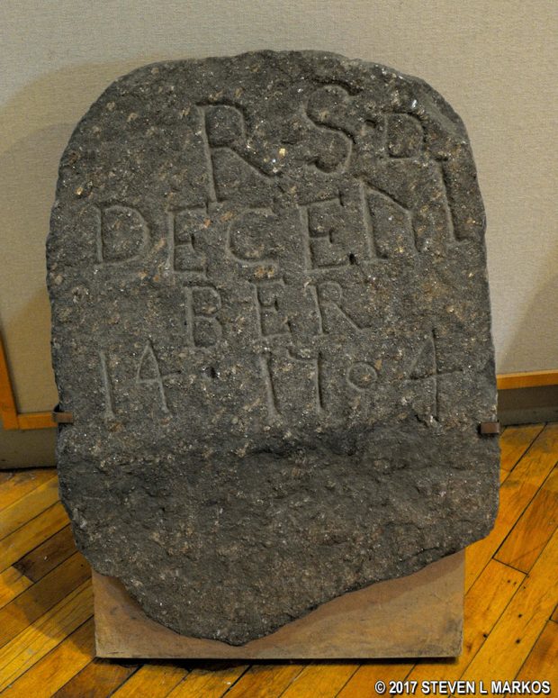 Original tombstone for Richard Shute from 1704 on display in the Visitor Center of Saint Paul's Church National Historic Site