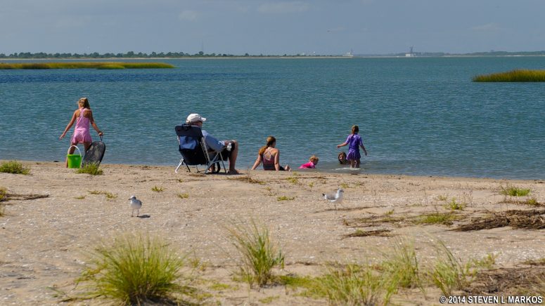 Family enjoys the calm waters of Toms Cove at Assateague Island National Seashore
