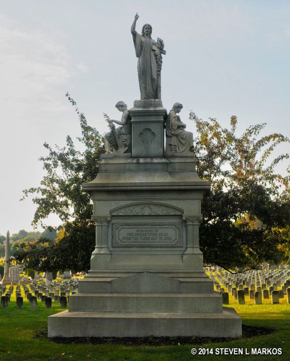 Memorial to the unidentified Johnstown Flood victims stands in front of their tombstone at Grandview Cemetery in Johnstown, Pennsylvania