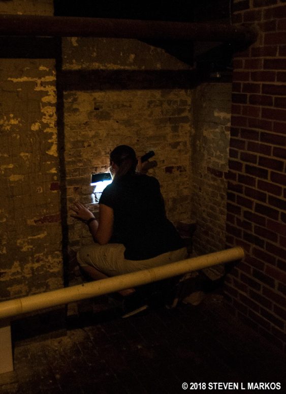 Taking a look inside a tomb in the King's Chapel crypt, Boston National Historical Park