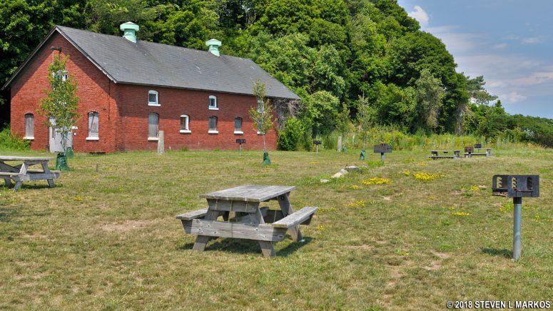Picnic area behind the Peddocks Island Visitor Center near a stable building from the Fort Andrews era, Boston Harbor Islands National Recreation Area