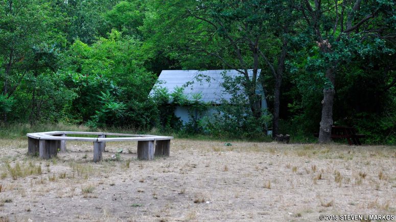 Shed and bench in the forested area near the West Salt Marsh on Cathleen Stone Island, Boston Harbor Islands National Recreation Area