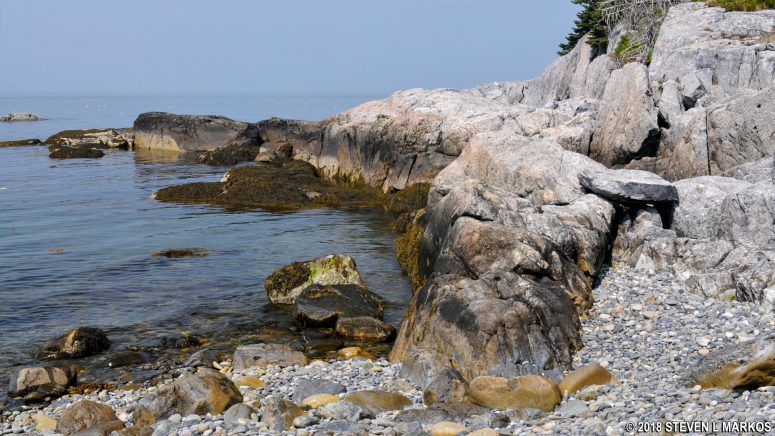 Rocks rim the cove at the second beach on the Isle au Haut's Western Head Trail, Acadia National Park