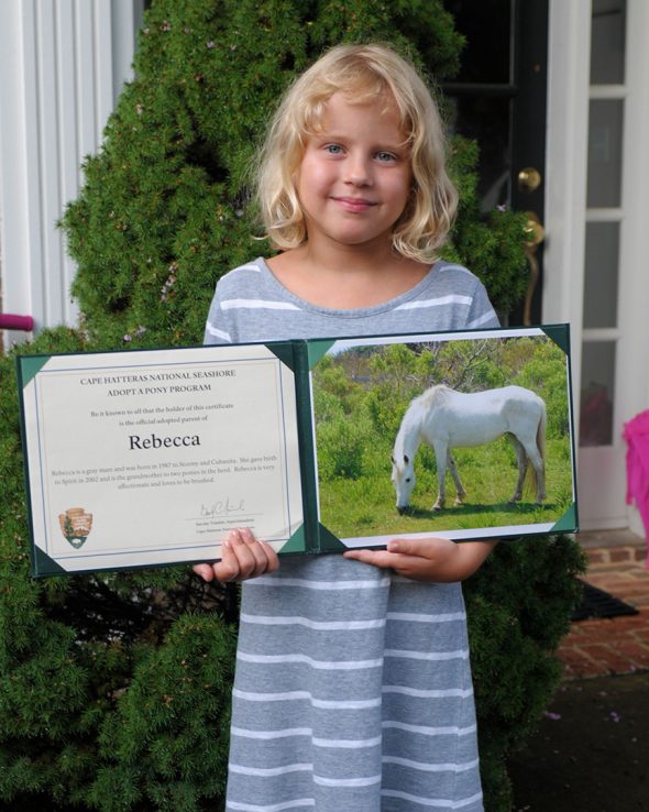 Sasha with her Adopt-A-Pony certificate and photo