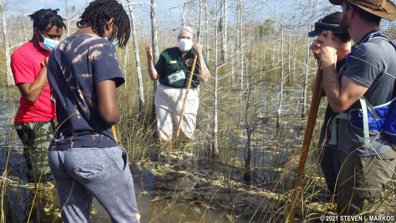 A National Park Service volunteer talks about the ecology of the slough