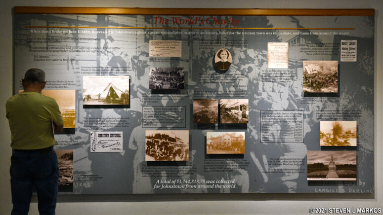 Visitor to Johnstown Flood National Memorial reads about the charitable outpouring in response to the Johnstown Flood, an exhibit in the Visitor Center museum 