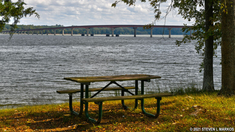 Picnic table at Colbert Ferry Park with a view of the John Coffee Bridge, Mile 327.3 on the Natchez Trace Parkway