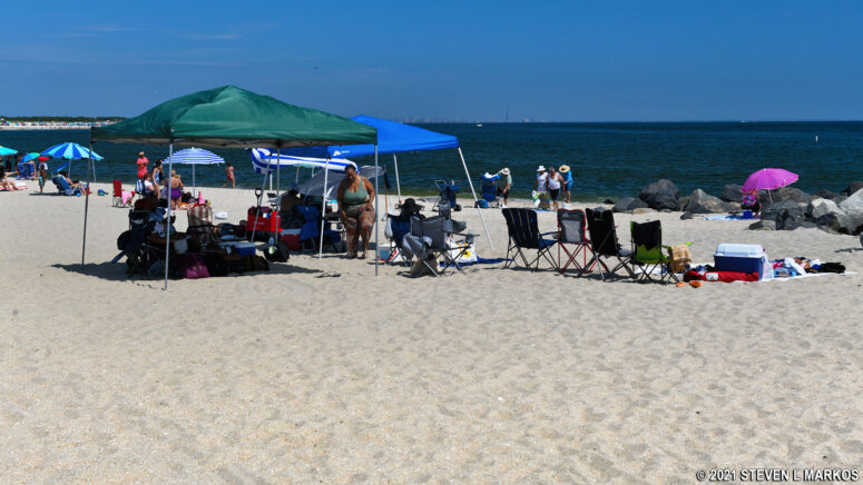 Canopies and umbrellas provide shade for visitors to Sandy Hook's Beach C in Gateway National Recreation Area