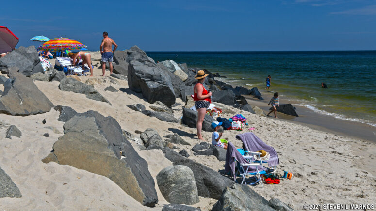 Beachgoers at the boulders of Beach C in the Sandy Hook unit of Gateway National Recreation Area