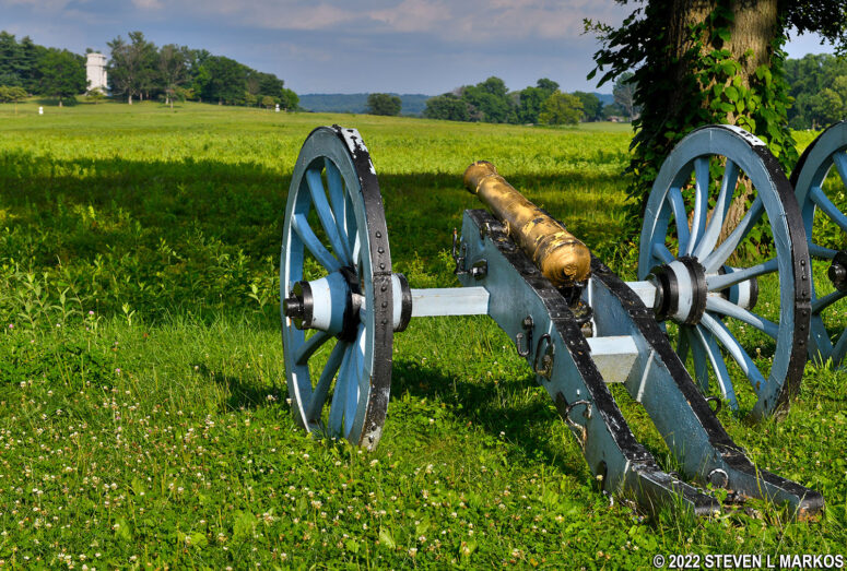 Cannon at Valley Forge's Artillery Park aims towards the National Memorial Arch