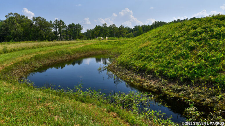 Earthen walls and rain water-filled moat around Fort Gregg at Petersburg National Battlefield