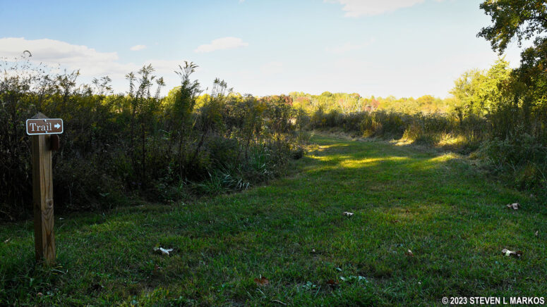 Western end of the Tibbs Trail veers from Gordon Drive and passes through a field, Appomattox Court House National Historical Park