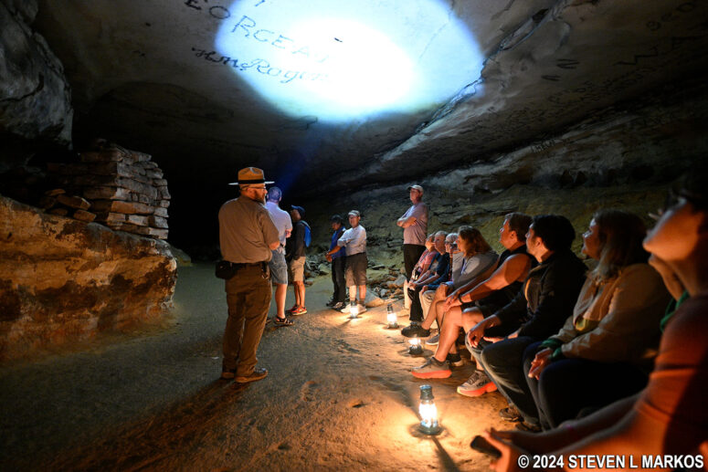Ranger points out graffiti on the ceiling of Gothic Avenue during the Star Chamber Lantern Tour at Mammoth Cave National Park