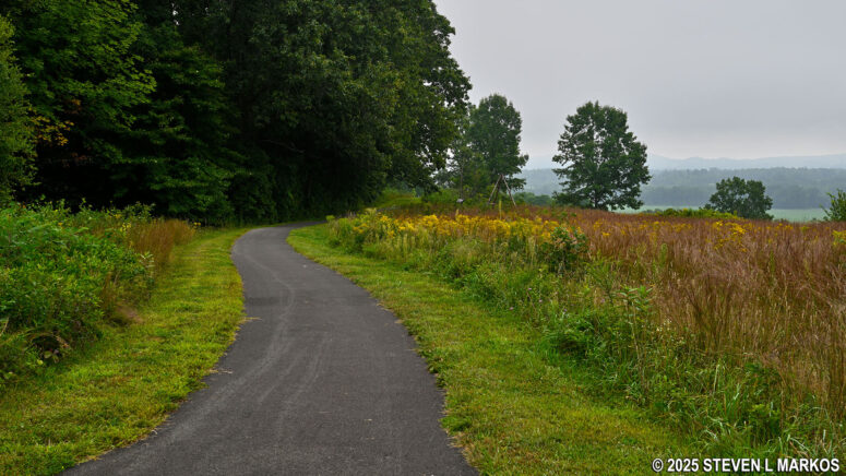 Paved path leads to exhibits at the Bemus Heights stop on the Saratoga Battlefield Tour, Saratoga National Historical Park