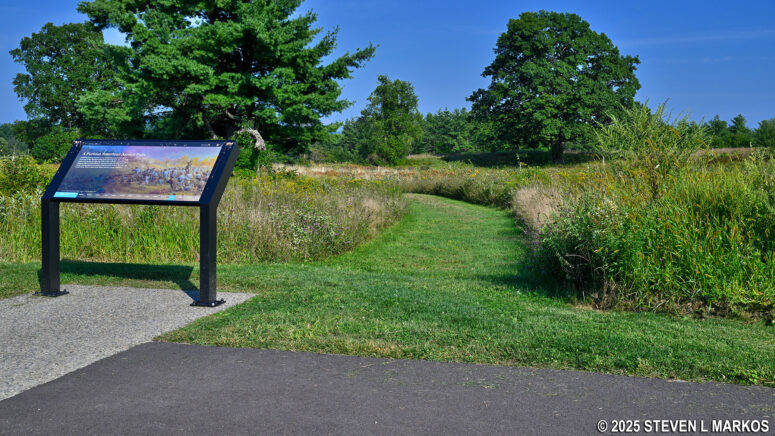 The Wilkinson Trail intersects with the paved path that circles the Freeman's Farm stop on the Saratoga Battlefield Tour, Saratoga National Historical Park