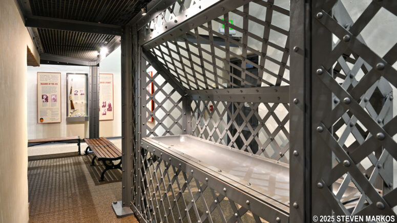 Wash bin and cage wall in the replica second jail exhibit at the Fort Smith National Historic Site Visitor Center