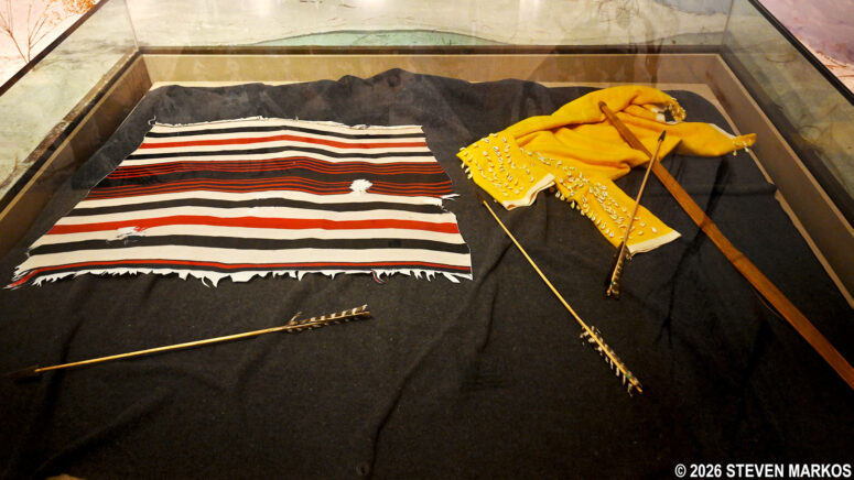 Wool blanket, arrows, and clothing on display at the Washita Battlefield National Historic Site Visitor Center