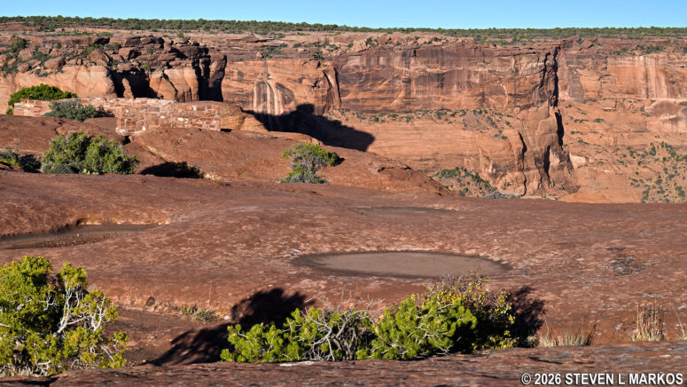 Stone-wall viewing area and ample space along the canyon rim at the Sliding House Overlook on Canyon de Chelly's South Rim Drive