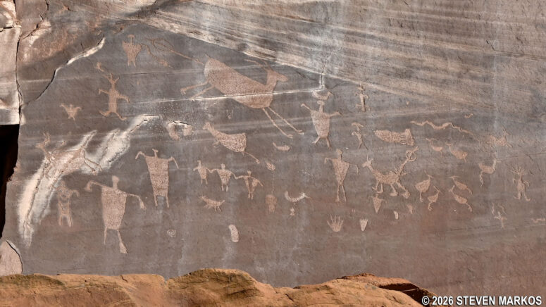 Petroglyphs high up on the wall of Canyon de Chelly at "petroglyph rock" depict a hunting scene, Canyon de Chelly National Monument