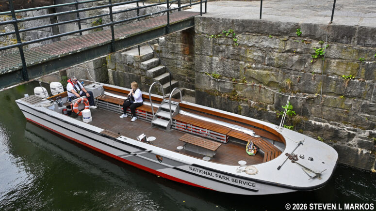 Participant on the Pawtucket Canal Boat Tour waits onboard the boat during a tour of the Francis Gate and Guard Locks in Lowell, Massachusetts