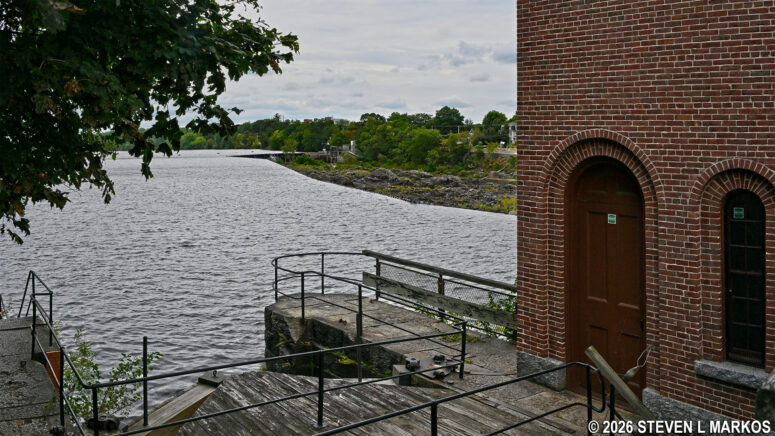 Stairs at the side of the Pawtucket Gatehouse lead down to a pool of water created by the Pawtucket Dam in Lowell, Massachusetts