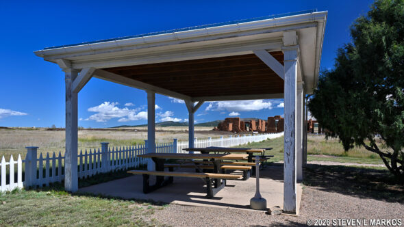 Picnic tables underneath a pavilion next to the Visitor Center at Fort Union National Monument