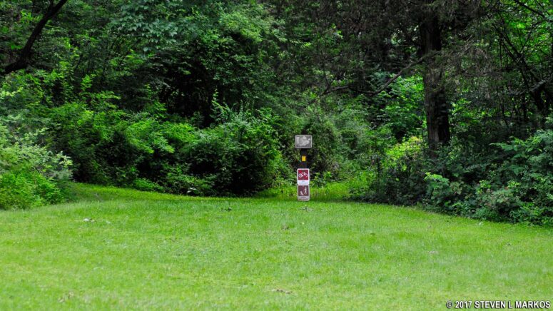 Continuation of the Yellow Trail on the northern end of the Trail Center parking lot in the Jockey Hollow unit of Morristown National Historical Park