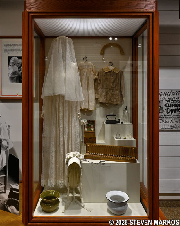 Typical Acadian wedding dress and a cigar press on display at the Prairie Acadian Cultural Center, Jean Lafitte National Historical Park and Preserve