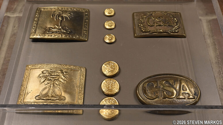 Display of Confederate / South Carolina uniform buttons and belt buckles at the museum inside the Fort Sumter Visitor Center, Fort Sumter and Fort Moultrie National Historical Park